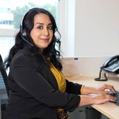 Klantenservicemedewerker Mediq zit achter haar bureau